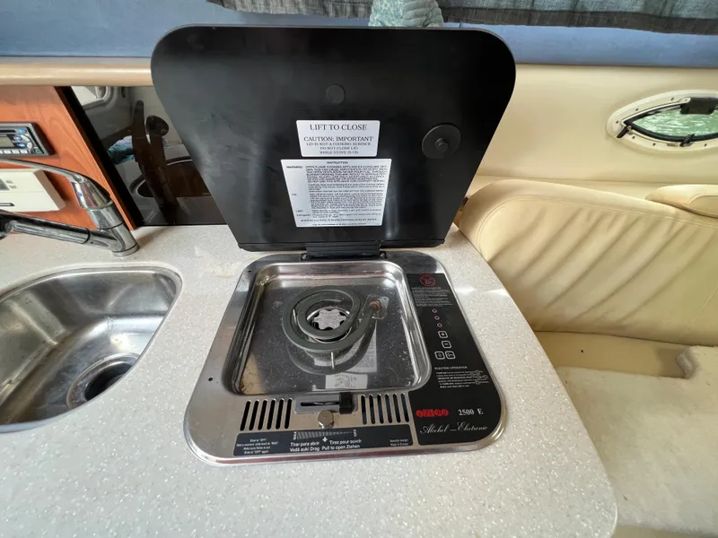 Slide: The Image of 2007 Bayliner 265 boat interior with stove and sink. - 15