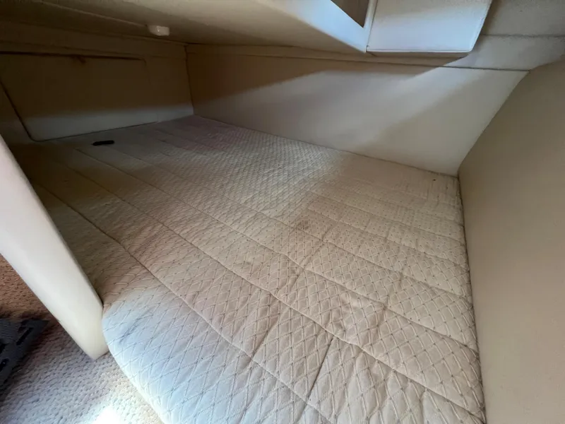 Slide: The Image of 2007 Bayliner 265 cabin interior with beige quilted bedding. - 18