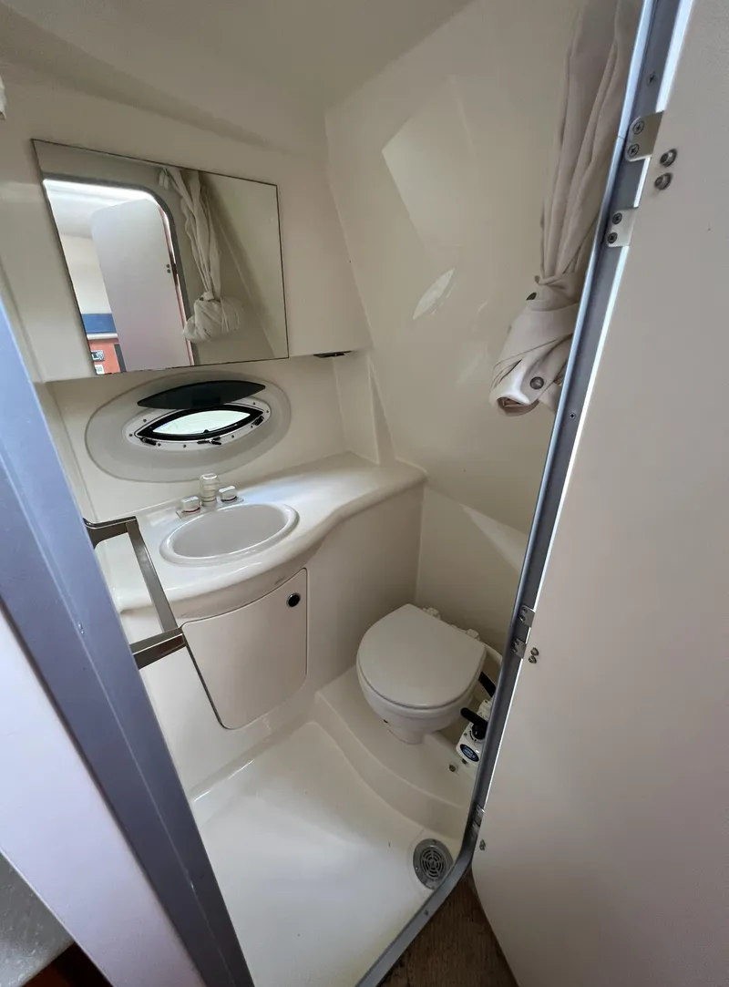Slide: The Image of 2007 Bayliner 265 boat bathroom with sink, toilet, and mirror. - 19
