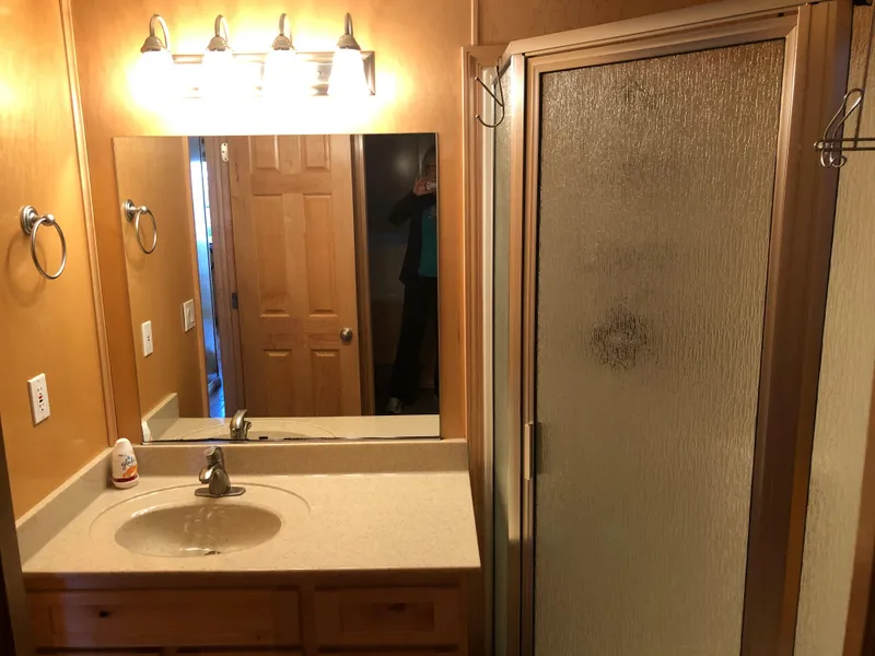 Slide: The Image of Small bathroom with vanity, mirror, and shower enclosure, Custom model The Entourage Shares #21,33 and 40 (2005). - 17