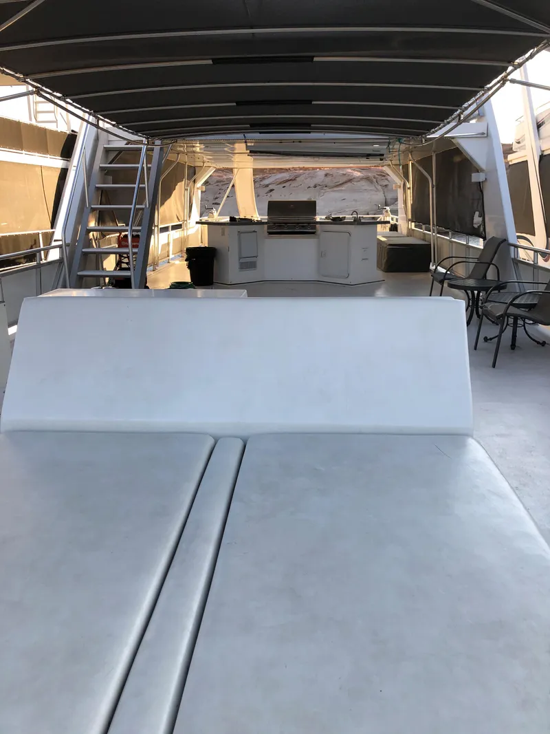 Slide: The Image of Spacious deck of 2005 Custom yacht 'The Entourage Shares #21,33 and 40' with seating and dining area. - 8