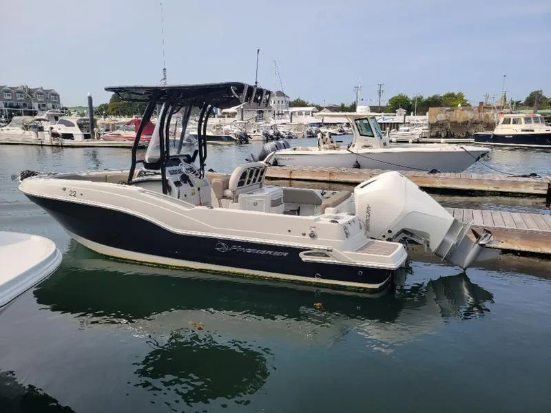 Slide: The Image of 2023 Finseeker 220 boat docked in a marina, featuring sleek design and powerful engine. - 12