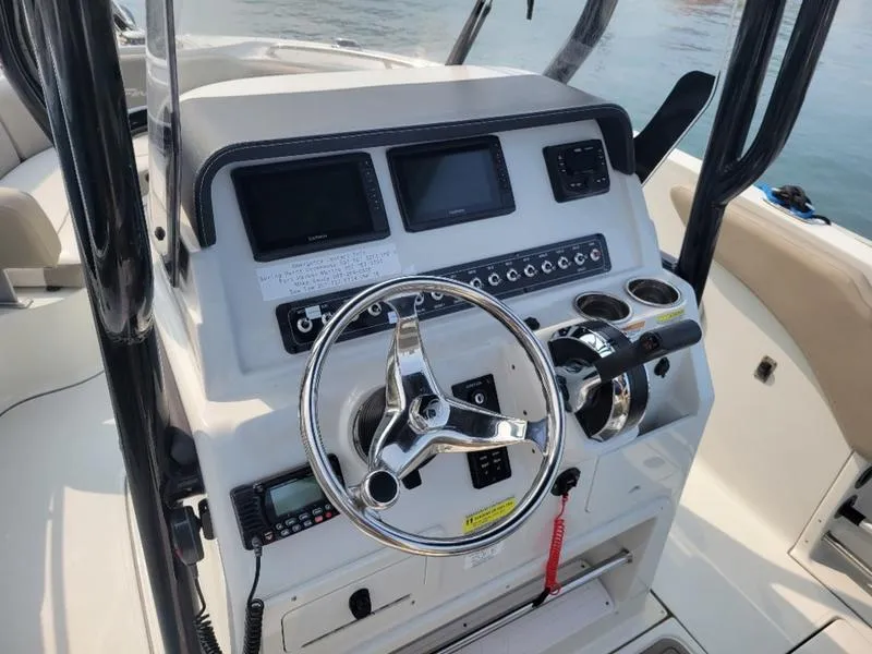 Slide: The Image of 2023 Finseeker 220 boat dashboard with steering wheel and control panel. - 2