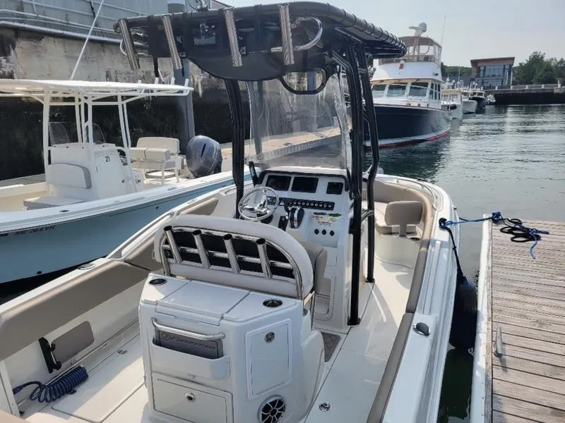 Slide: The Image of 2023 Finseeker 220 boat docked at marina, featuring modern console and seating. - 3