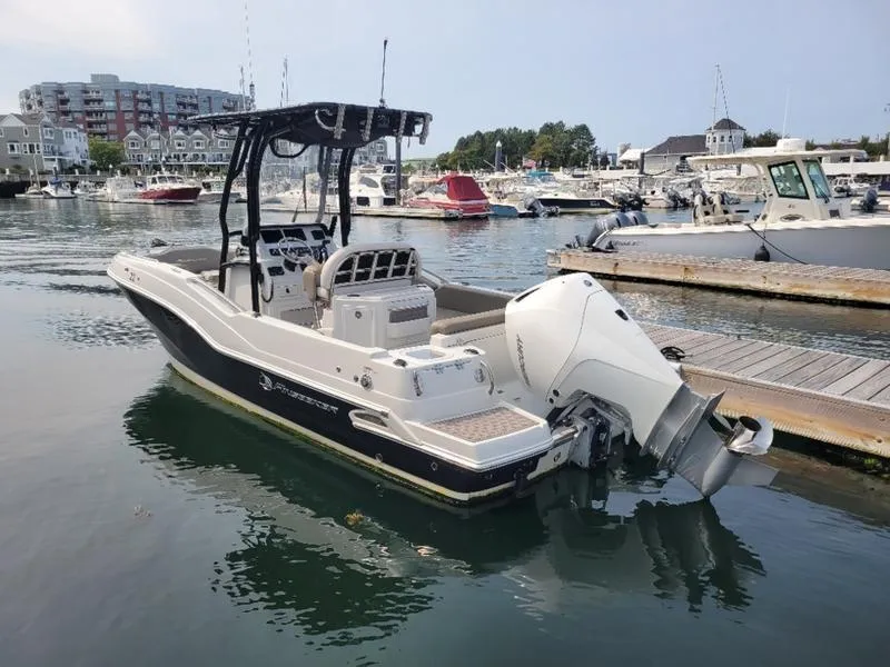 Slide: The Image of 2023 Finseeker 220 boat docked in a marina, featuring a sleek design and powerful engine. - 4