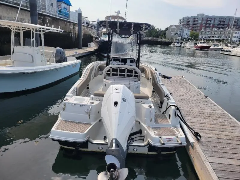 Slide: The Image of 2023 Finseeker 220 boat docked in a marina, rear view. - 7