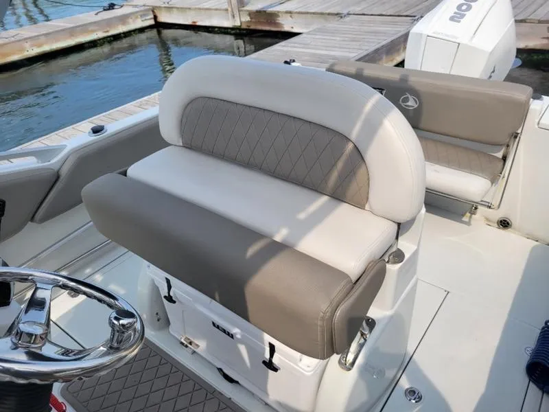 Slide: The Image of 2023 Finseeker 220 boat interior with cushioned seating and steering wheel. - 9