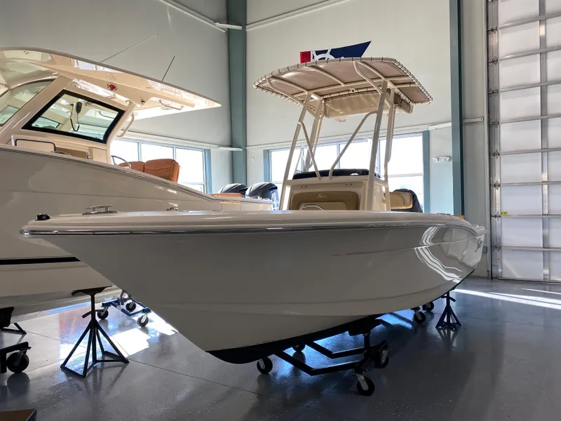 Slide: The Image of 2024 Scout 195 Sportfish boat displayed in a showroom. - 0