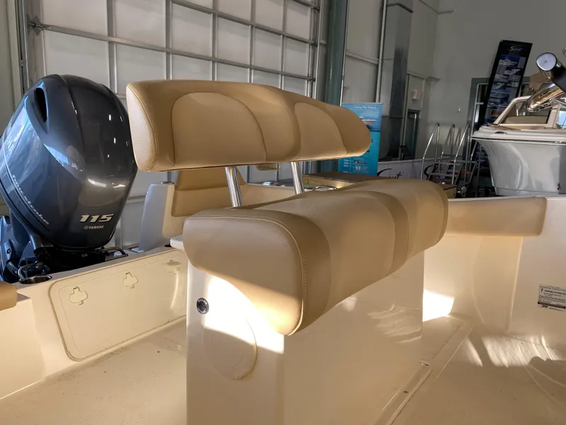 Slide: The Image of 2024 Scout 195 Sportfish boat interior with tan seating and Yamaha 115 outboard motor. - 2