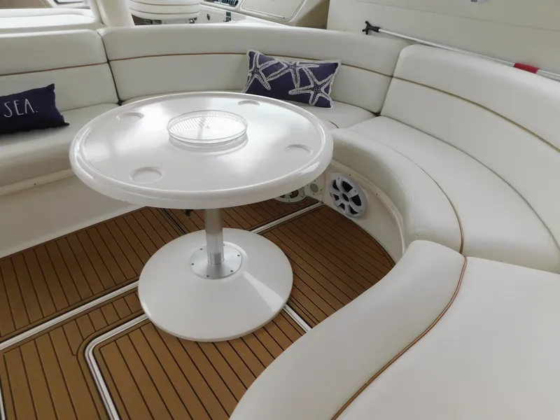 Slide: The Image of Interior of a 2004 Sea Ray 600 Sun Sport yacht with table and seating area. - 10