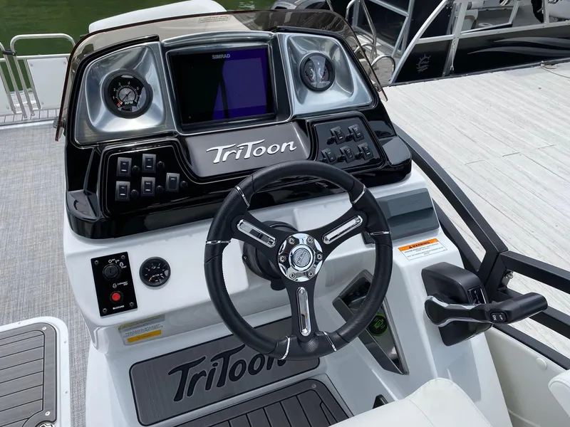 Slide: The Image of 2024 JC Neptoon Sport 23TT DSL boat dashboard with steering wheel and control panel. - 15