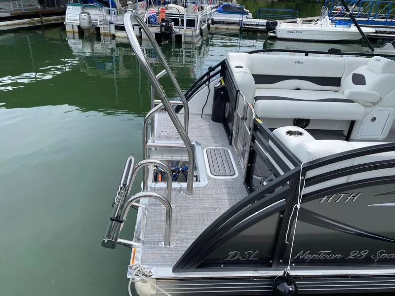 Slide: The Image of 2024 JC Neptoon Sport 23TT DSL pontoon boat docked at marina. - 22