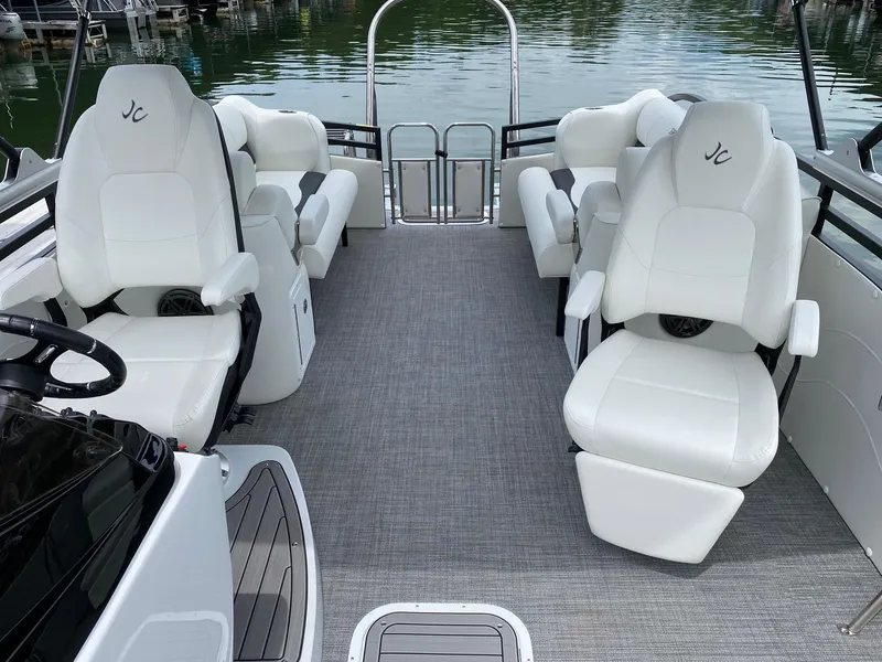 Slide: The Image of 2024 JC Neptoon Sport 23TT DSL pontoon boat interior with white seating. - 10