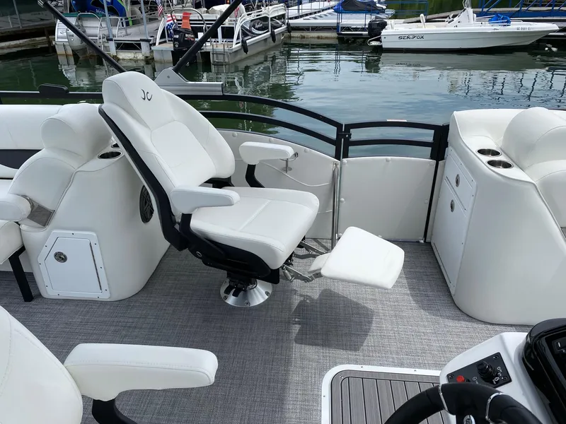 Slide: The Image of 2024 JC Neptoon Sport 23TT DSL boat interior with white captain's chair and console. - 12