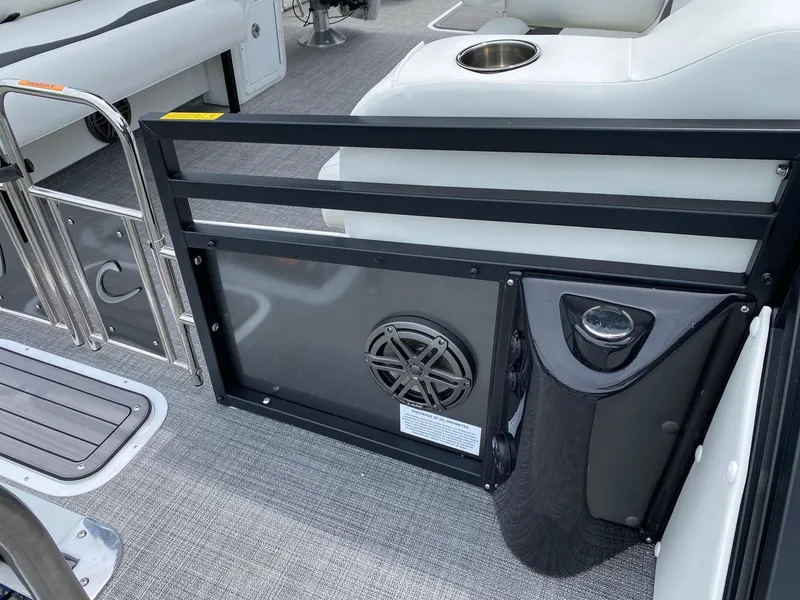Slide: The Image of 2024 JC Neptoon Sport 23TT DSL boat interior with seating and speaker. - 23