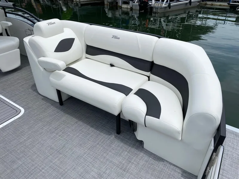 Slide: The Image of 2024 JC Neptoon Sport 23TT DSL boat with white and black cushioned seating. - 4