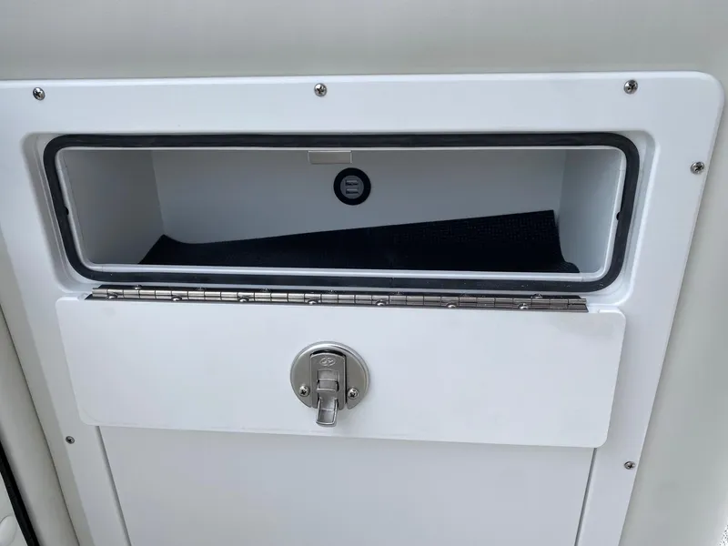 Slide: The Image of Storage compartment of 2024 JC Neptoon Sport 23TT DSL boat with secure latch. - 9