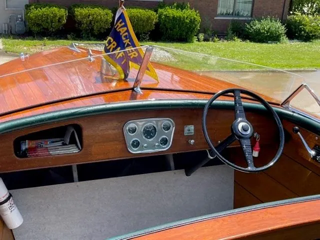 Slide: The Image of 1949 Hacker-Craft Utility boat interior with wooden dashboard and steering wheel. - 3