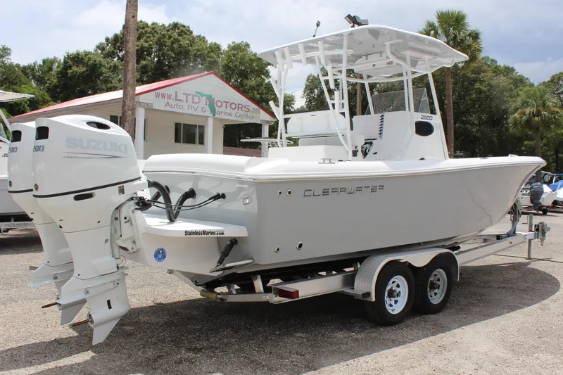 Slide: The Image of 2024 Clearwater 2800 boat on trailer with dual Suzuki outboard motors. - 4