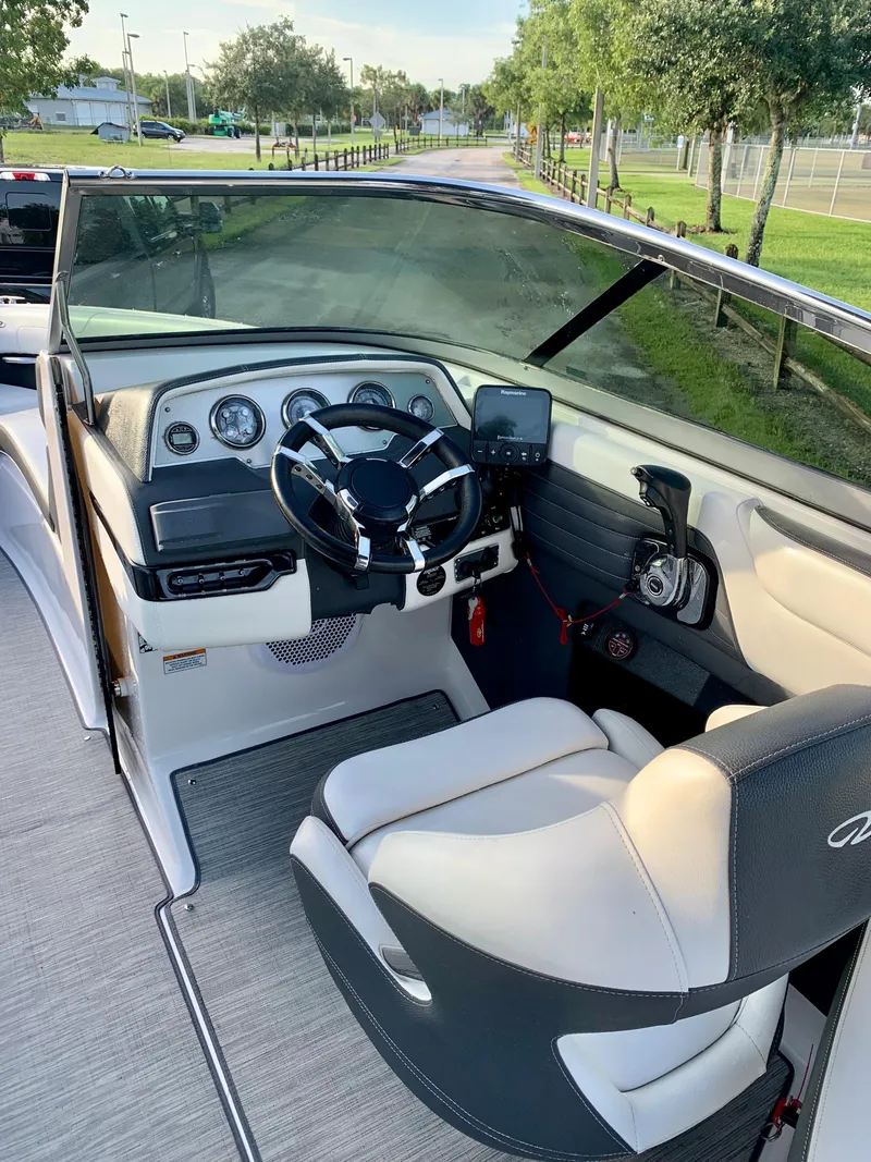 Slide: The Image of 2016 Regal Fastrac boat interior with steering wheel and dashboard. - 10