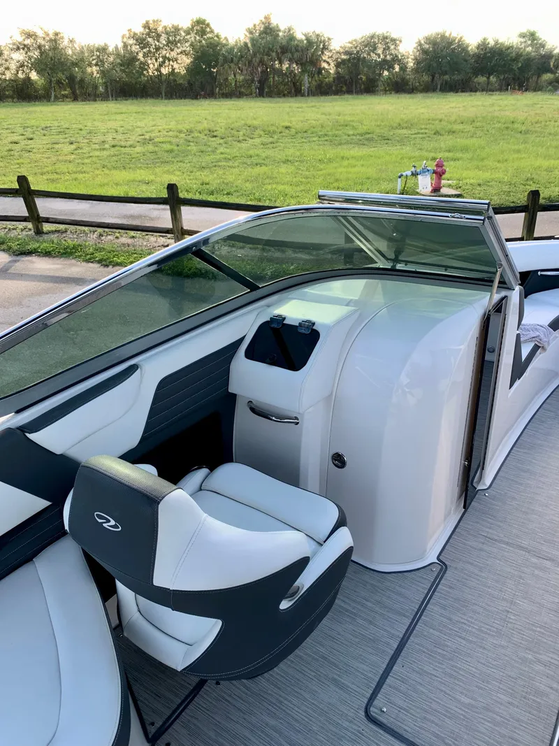 Slide: The Image of 2016 Regal Fastrac boat interior with captain's chair and dashboard. - 11