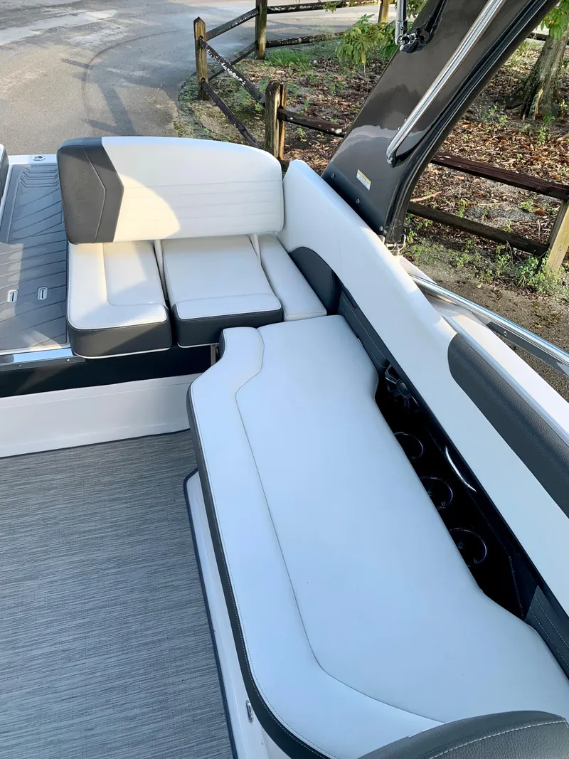 Slide: The Image of 2016 Regal Fastrac boat interior seating area with white and gray upholstery. - 12