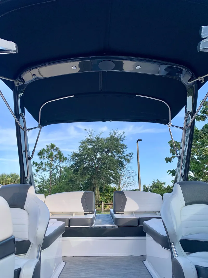 Slide: The Image of 2016 Regal Fastrac boat interior with canopy and seating. - 14