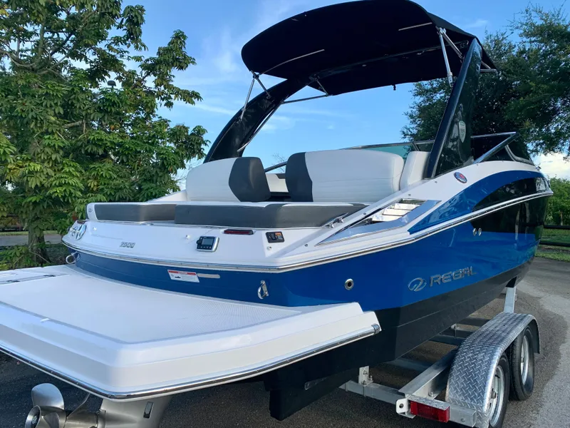 Slide: The Image of 2016 Regal Fastrac boat on trailer with blue and white exterior. - 19