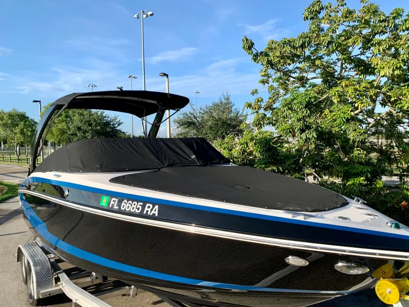 Slide: The Image of 2016 Regal Fastrac boat on trailer with cover, parked outdoors. - 4