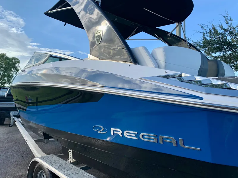 Slide: The Image of 2016 Regal Fastrac boat on trailer, blue and white exterior. - 7