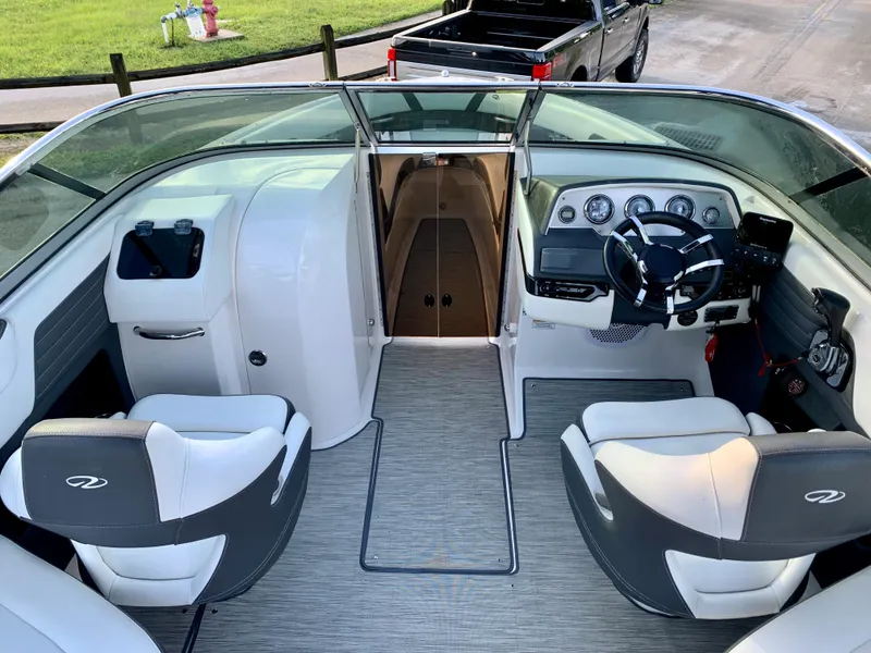 Slide: The Image of 2016 Regal Fastrac boat interior with dual captain seats and modern dashboard. - 8