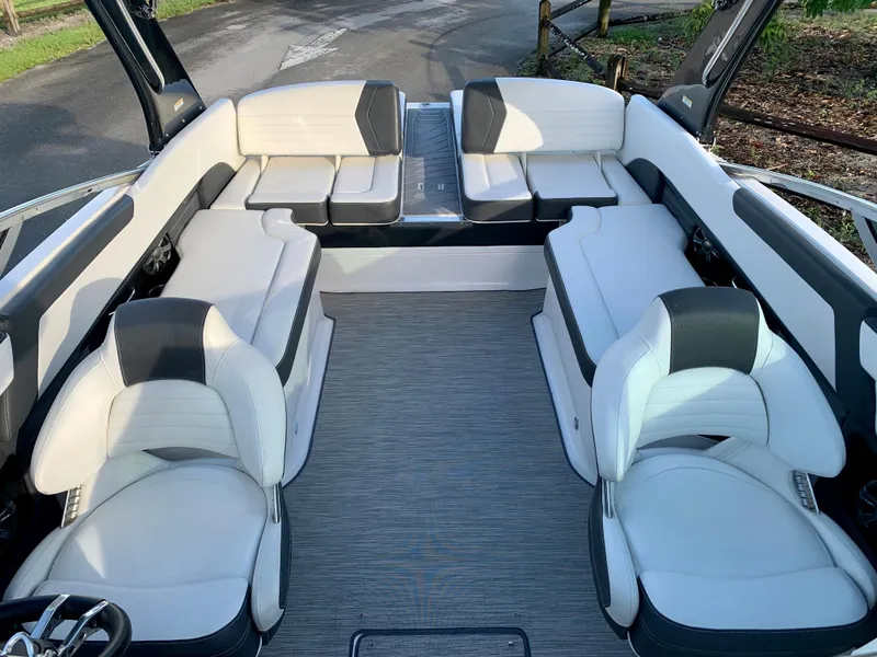Slide: The Image of 2016 Regal Fastrac boat interior with white and gray seating. - 9