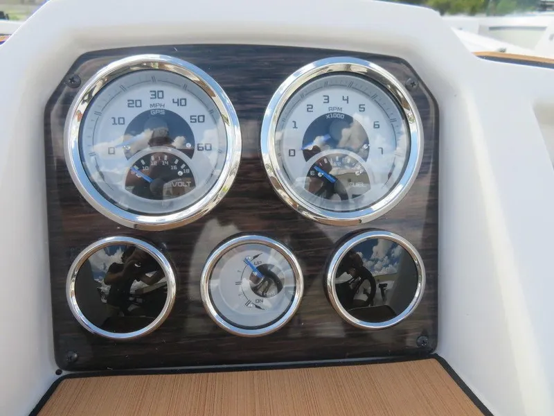 Slide: The Image of Dashboard of 2023 Starcraft SVX OB 231 OB boat with gauges and controls. - 12