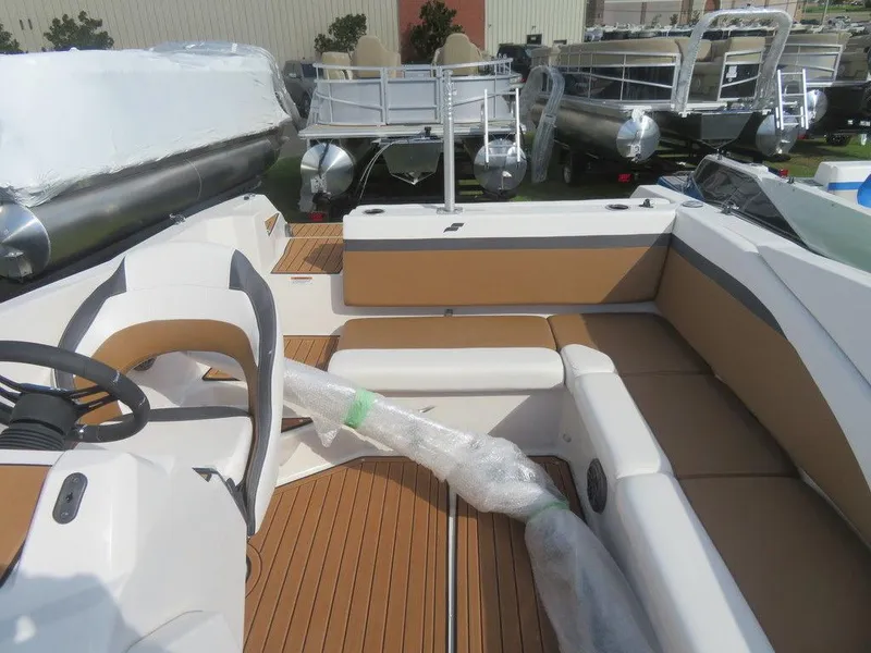 Slide: The Image of 2023 Starcraft SVX OB 231 OB boat interior with tan and white seating. - 17