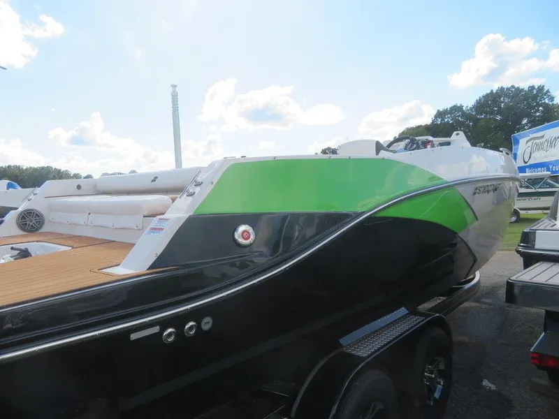 Slide: The Image of 2023 Starcraft SVX OB 231 OB boat with green and black exterior on a trailer. - 4