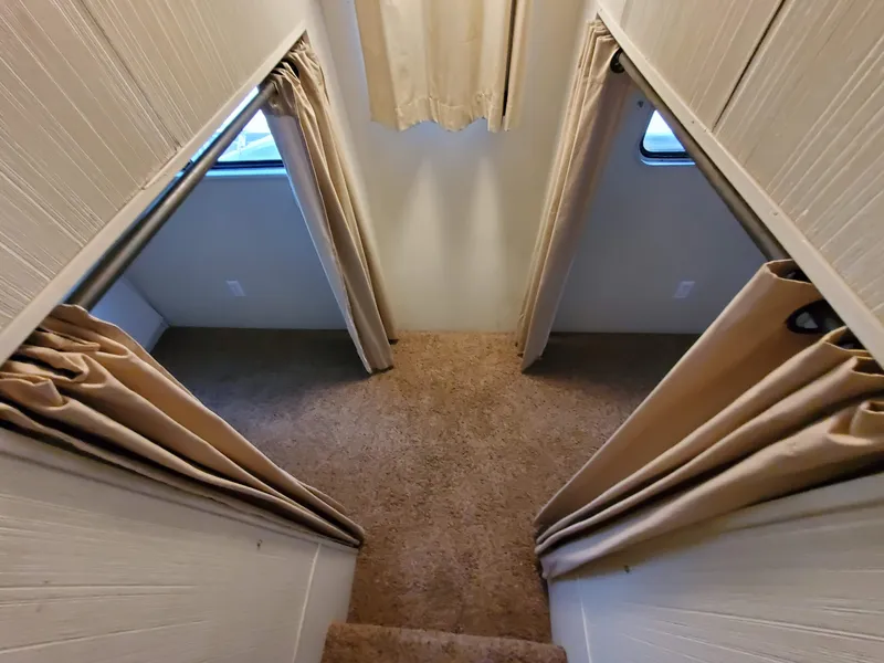 Slide: The Image of Interior view of 1995 Skipperliner 55x15 Houseboat with carpeted stairs and curtained windows. - 16