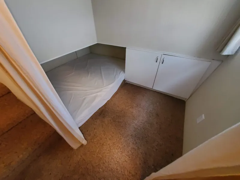 Slide: The Image of 1995 Skipperliner 55x15 Houseboat interior bedroom with bed and storage cabinets. - 17