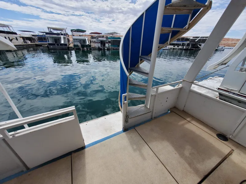 Slide: The Image of 1995 Skipperliner 55x15 Houseboat with spiral staircase and marina view. - 22
