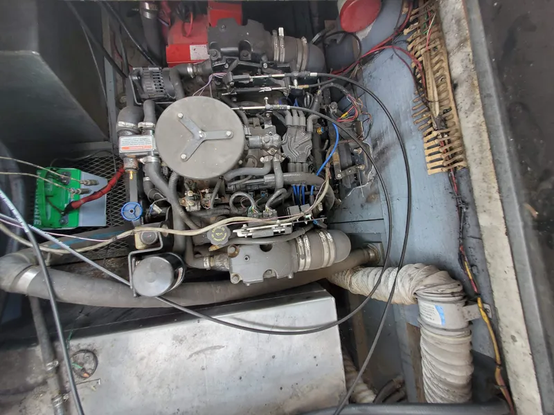 Slide: The Image of 1995 Skipperliner 55x15 Houseboat engine compartment with visible wiring and components. - 25