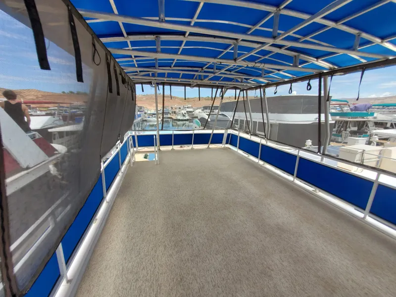 Slide: The Image of 1995 Skipperliner 55x15 Houseboat upper deck with blue canopy. - 28