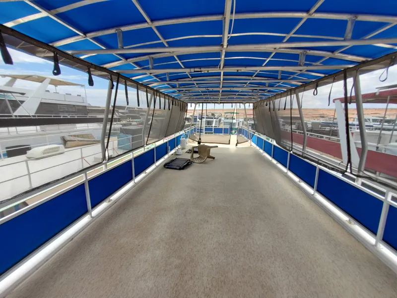 Slide: The Image of 1995 Skipperliner 55x15 Houseboat with spacious covered deck and blue canopy. - 29