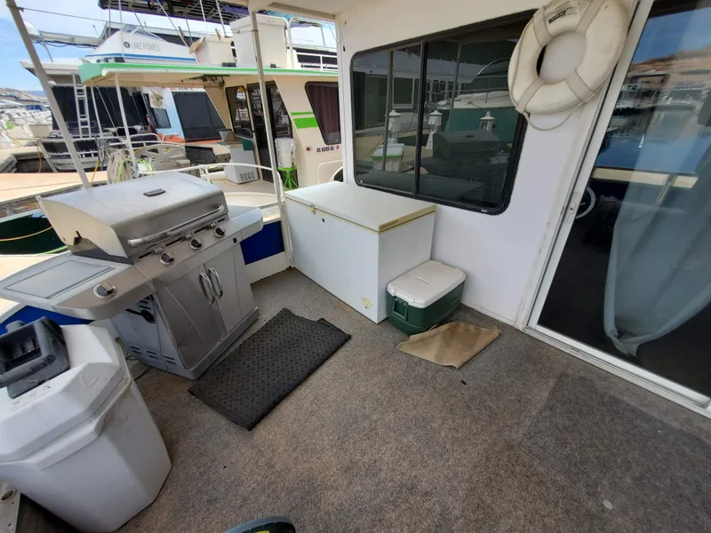Slide: The Image of 1995 Skipperliner 55x15 Houseboat deck with grill, storage, and life preserver. - 3