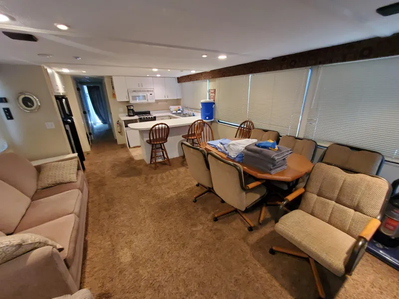 Slide: The Image of Interior of a 1995 Skipperliner 55x15 Houseboat with kitchen and dining area. - 5