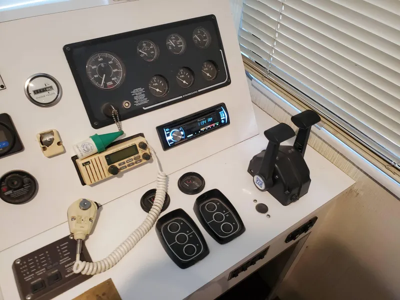 Slide: The Image of Control panel of a 1995 Skipperliner 55x15 Houseboat with various gauges and controls. - 9