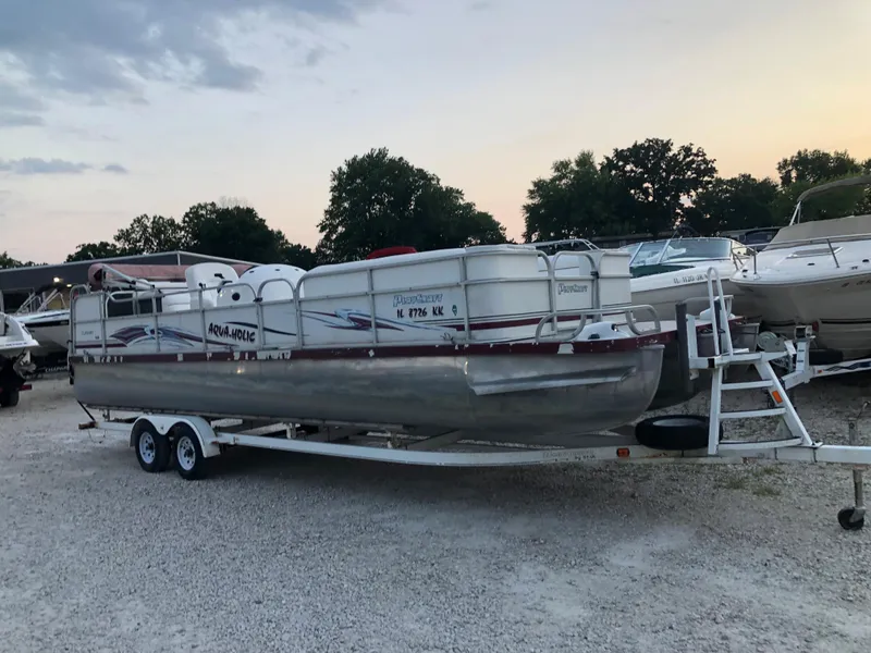 The Image of 2008 PlayCraft 2600 Clipper pontoon boat on a trailer at sunset. - 0