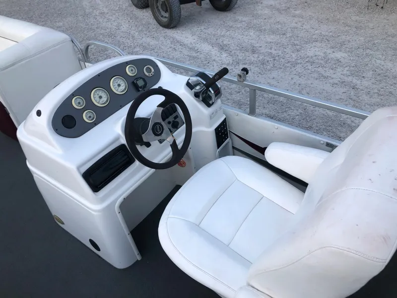 Slide: The Image of 2008 PlayCraft 2600 Clipper boat dashboard and captain's chair. - 10