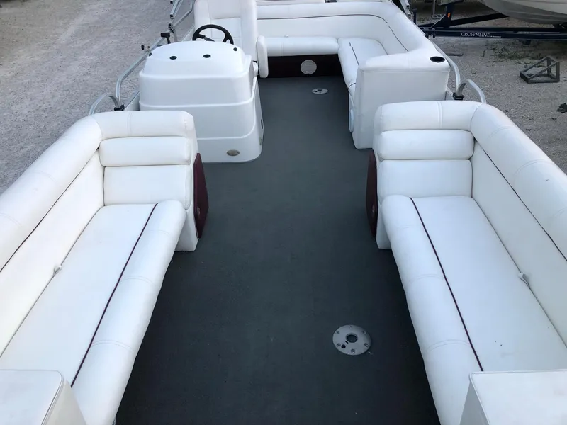 Slide: The Image of 2008 PlayCraft 2600 Clipper pontoon boat with white cushioned seating. - 6