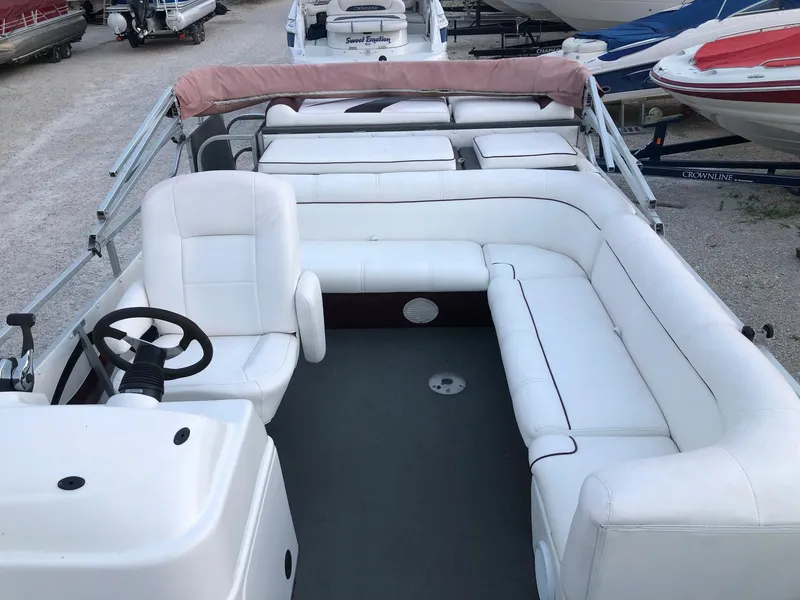 Slide: The Image of 2008 PlayCraft 2600 Clipper pontoon boat with white seating and steering console. - 7
