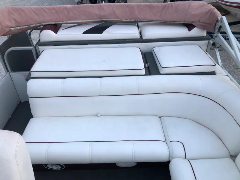 Slide: The Image of 2008 PlayCraft 2600 Clipper boat with white cushioned seating and pink canopy. - 9