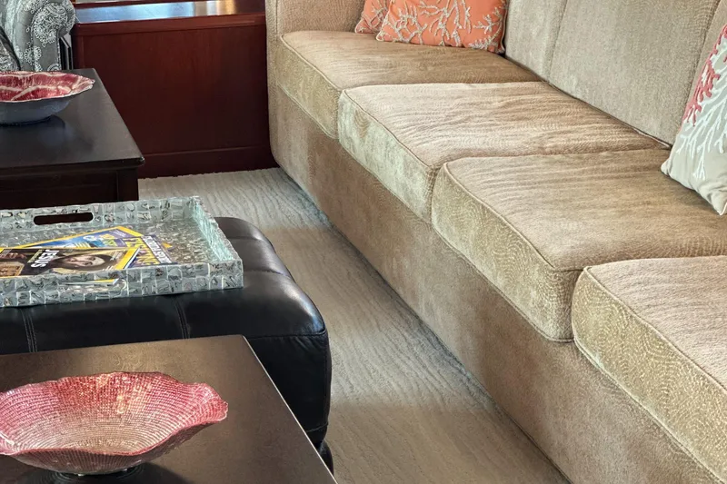 Slide: The Image of Luxurious interior of 2015 Broward Raised Pilothouse M/Y with beige sofa and decorative pillows. - 24